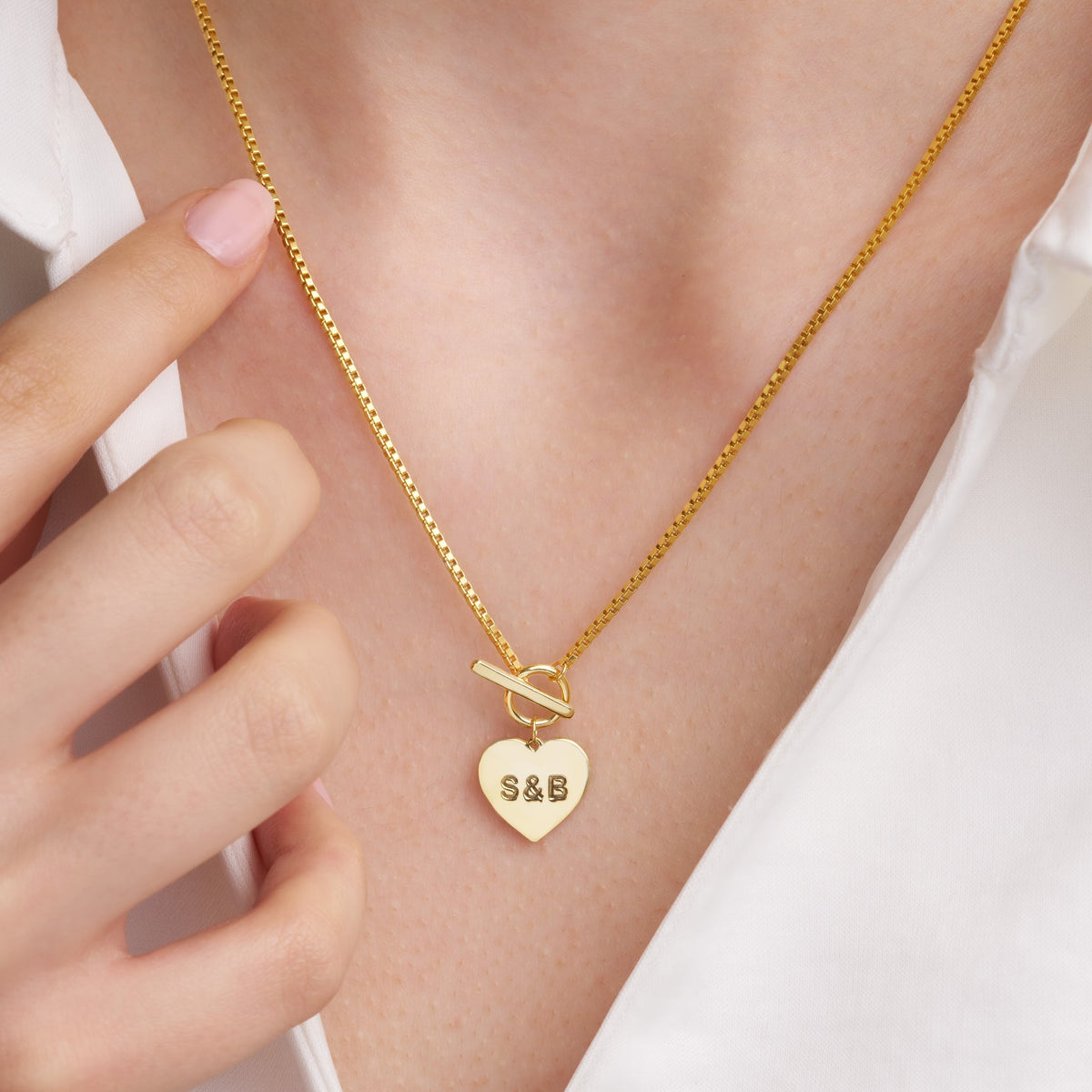 Engraved heart pendant and chain, close-up detail