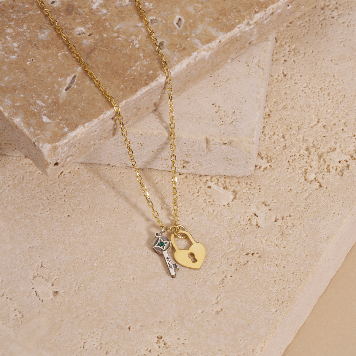 Engraved key and heart lock birthstone necklace: gold heart padlock and silver birthstone key on a gold chain