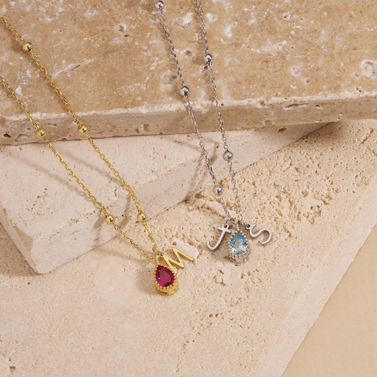 Close-up of the letter and birthstone charms on a beaded chain