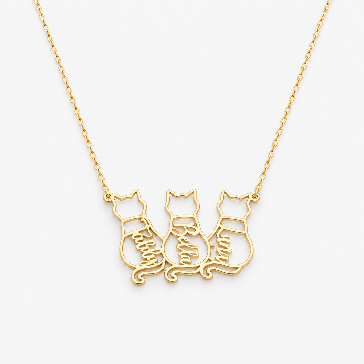 Gold personalized cat necklace with three cat outlines named Teddy, Bella and Luna on a white background