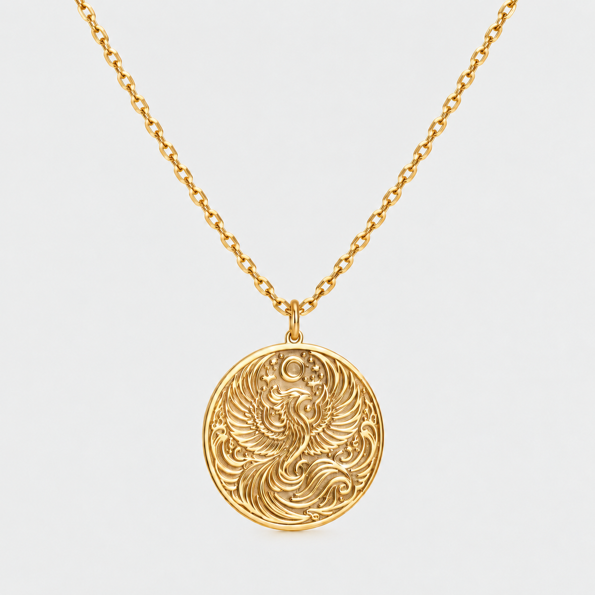 Gold phoenix necklace with a round engraved phoenix pendant on a cable chain