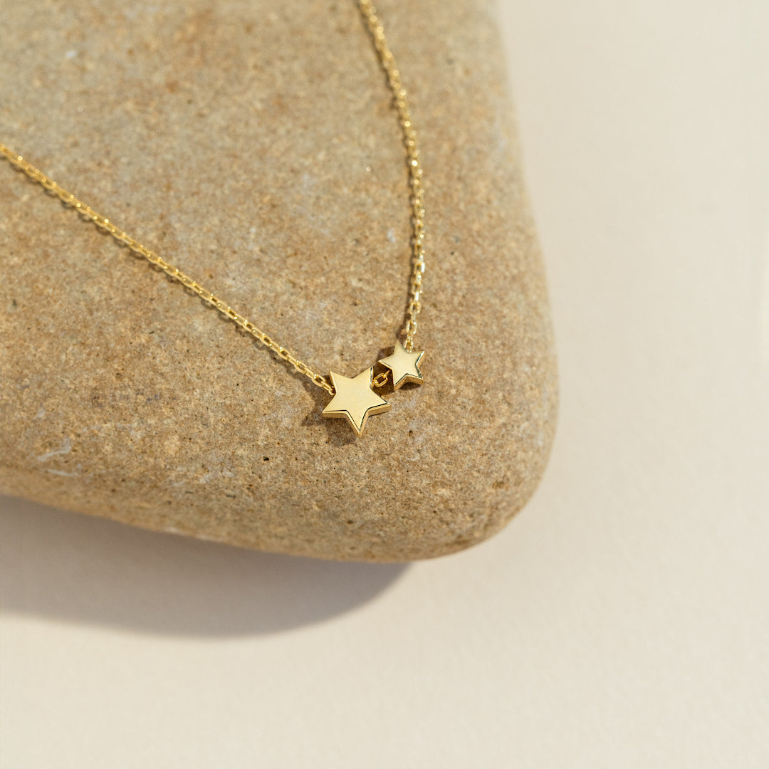 Gold star necklace on a stone surface
